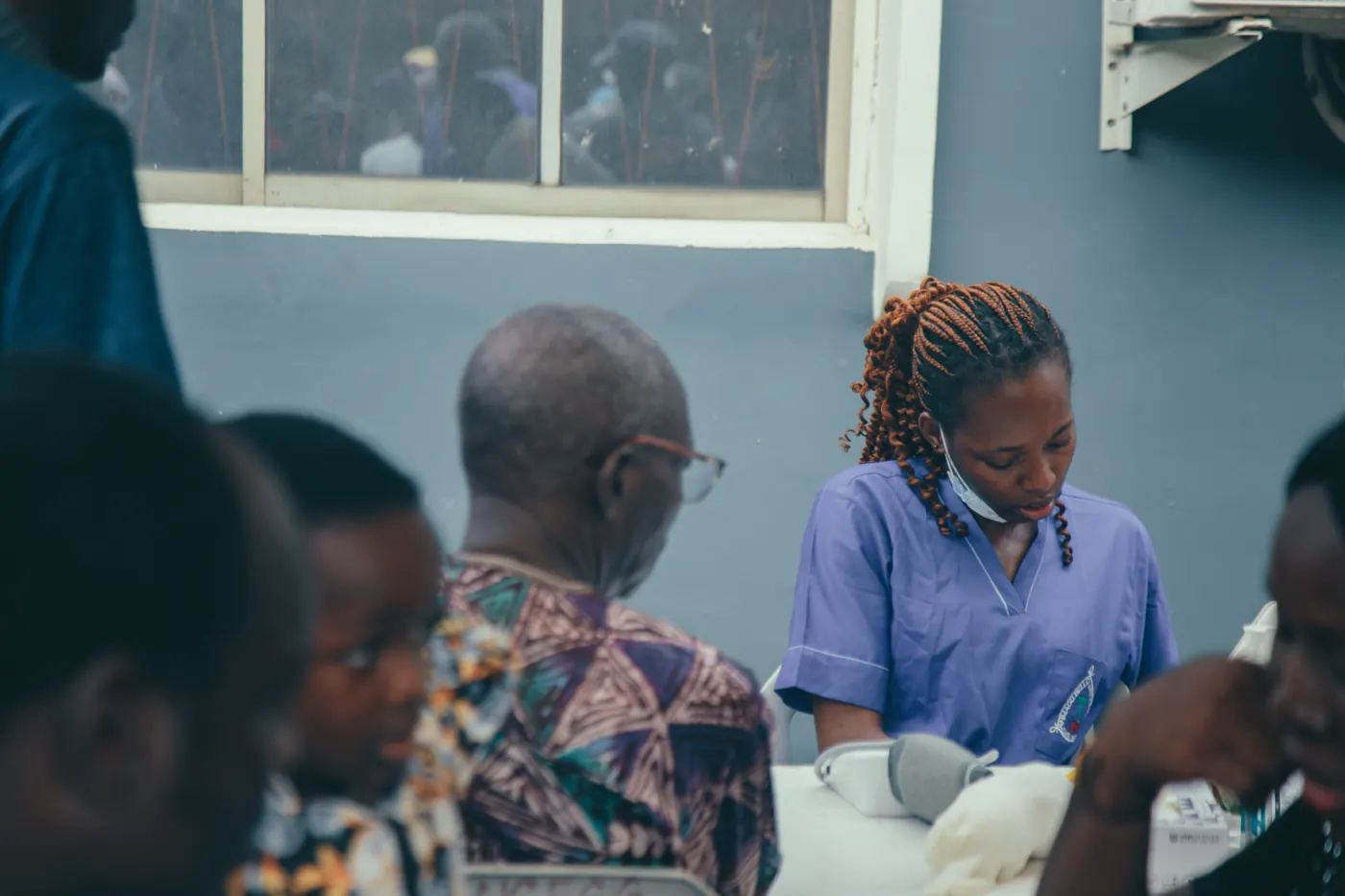 A nurse attending to an elderly man at the free medical outreach in Mushin.