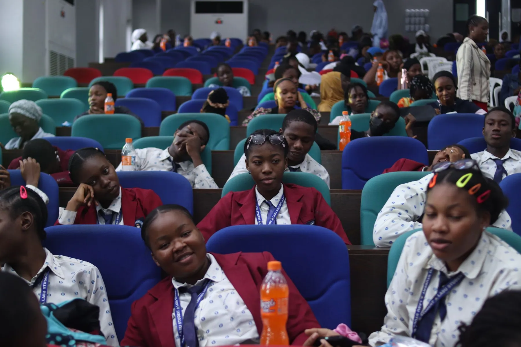 Students attending a lecture in a bright hall in Lagos.