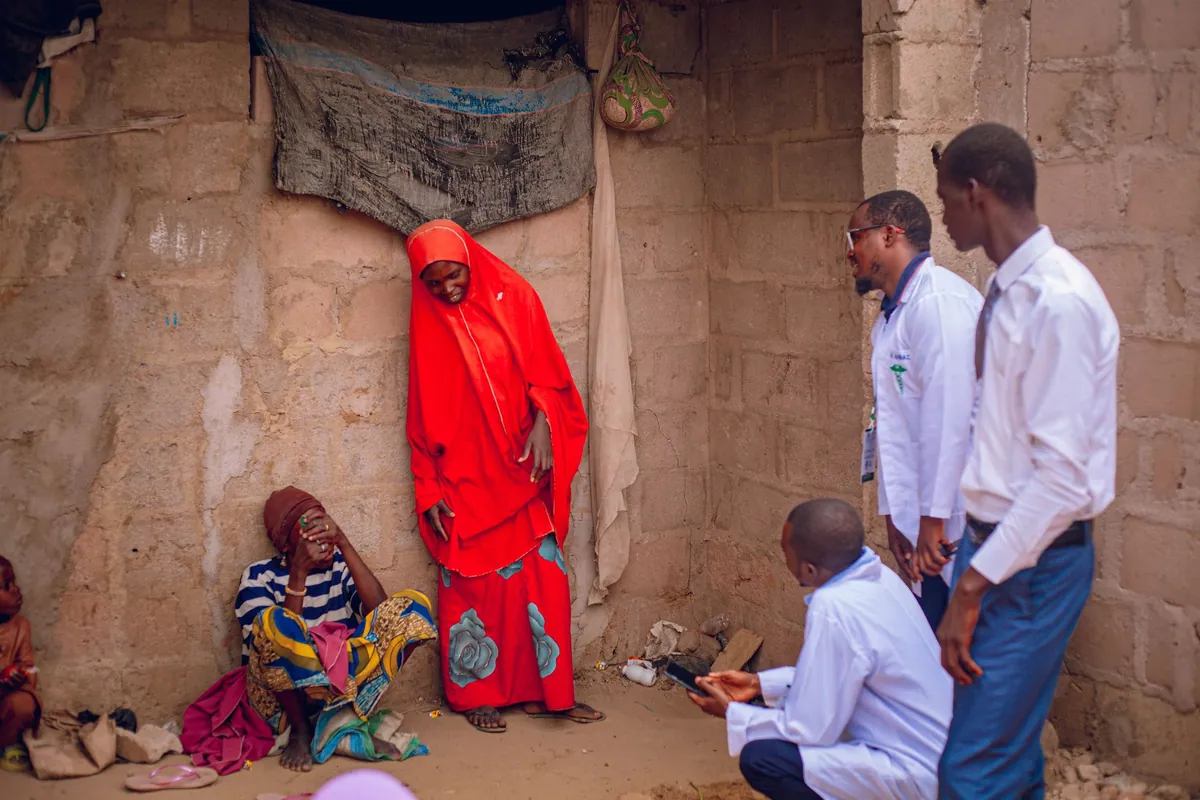 Healthcare workers meeting residents at a rural community health session.