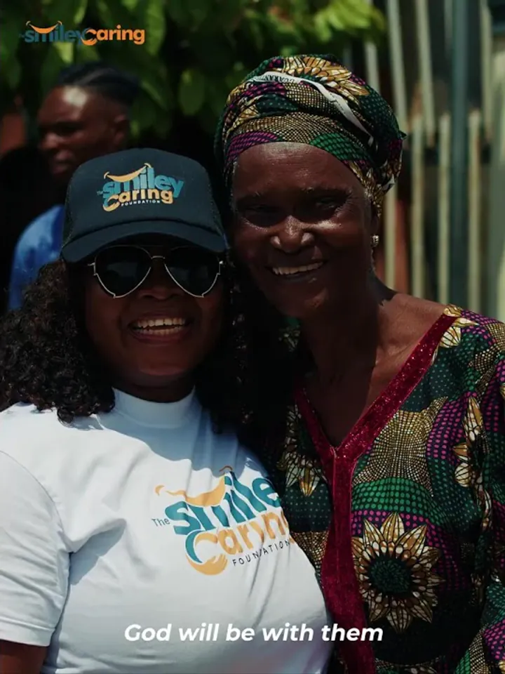 A Smiley Caring Foundation volunteer and an elderly resident smiling together at the Mushin outreach.
